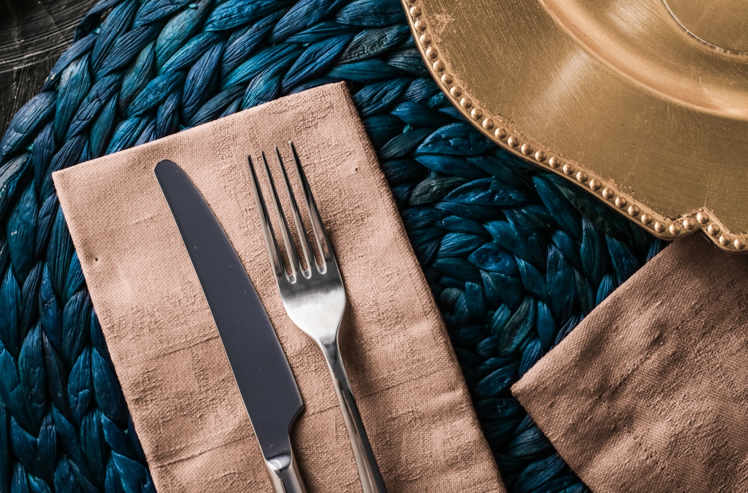 Holiday table setting with beige napkin and silver cutlery, food styling props, vintage set for wedding, event, date, party or luxury home decor brand design