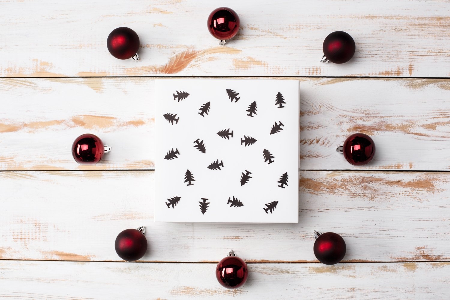 Christmas decoration and gift box over wooden background. Above.